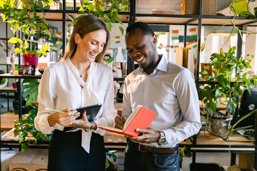 a man and a woman holding papers