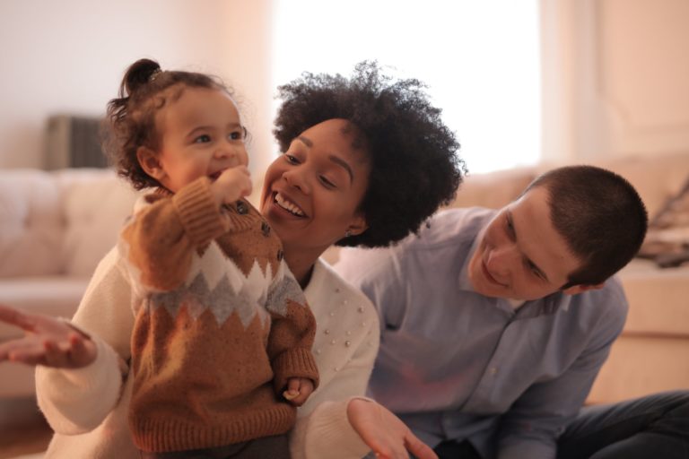 a family sitting on a couch