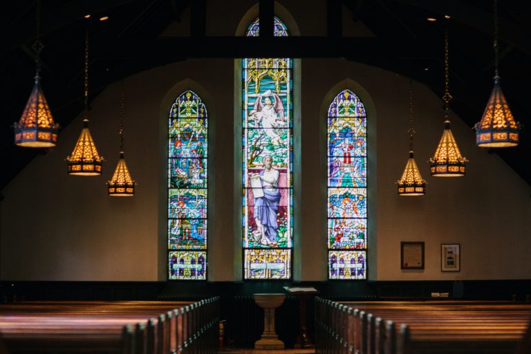 a large room with stained glass windows