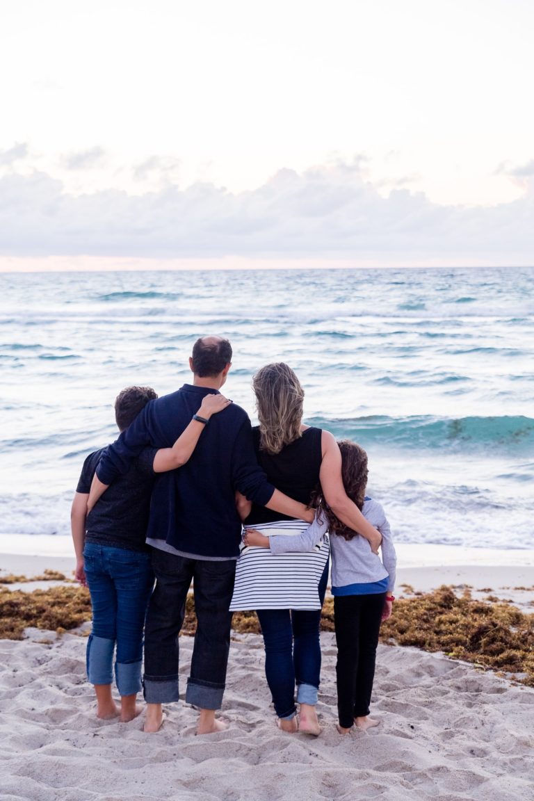 a group of people kissing on a beach