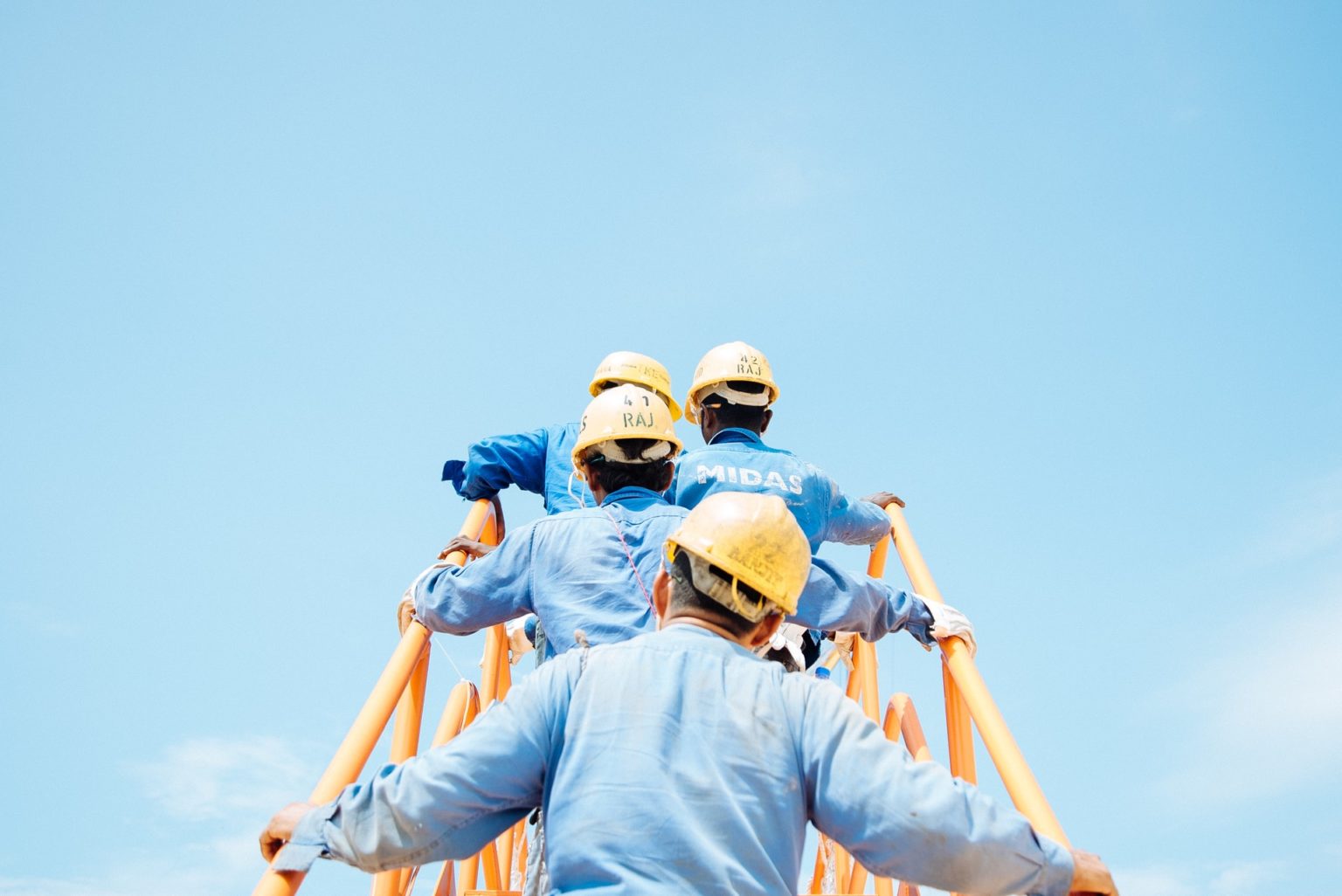 a group of people wearing hard hats