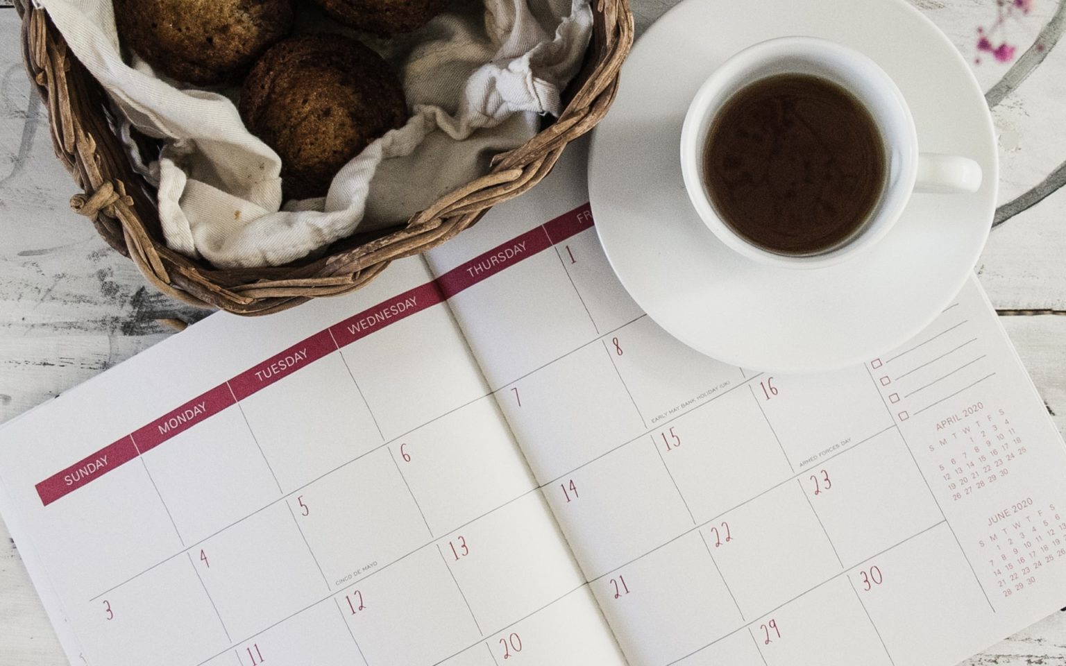 a basket of food and a cup of coffee