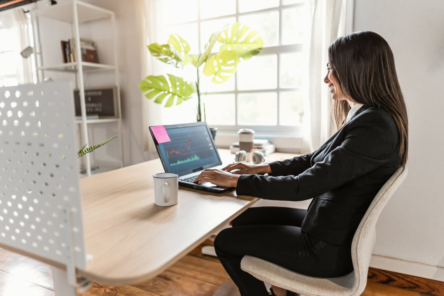 a woman sitting at a table using a laptop