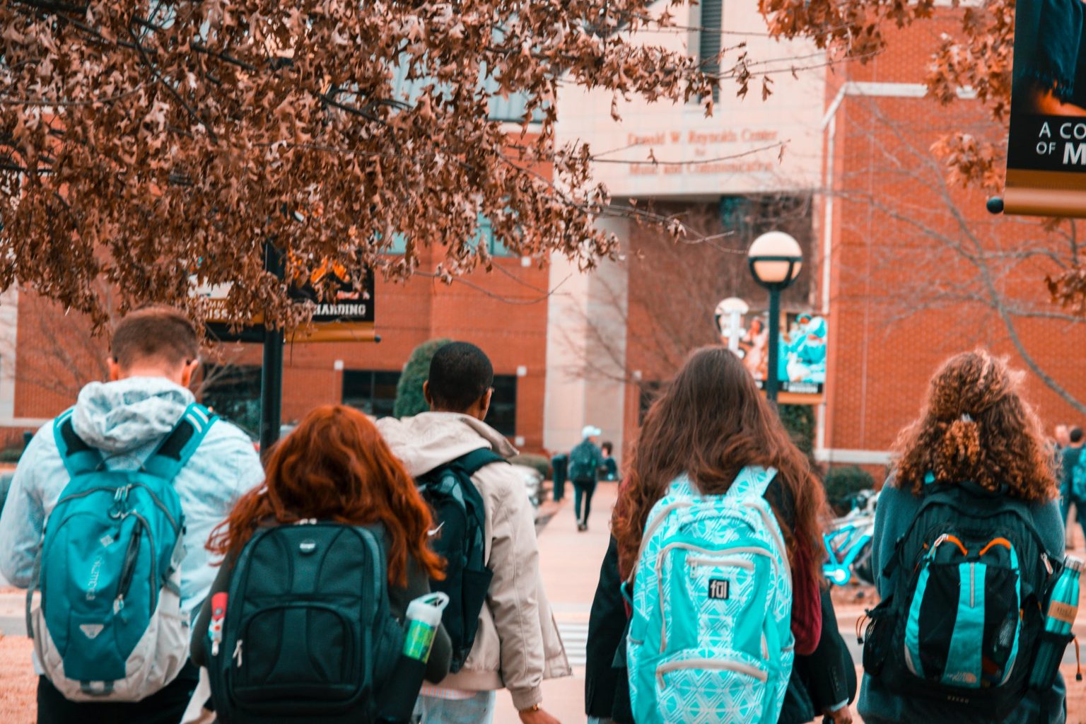 a group of people walking through a building